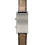 Back view of the Cartier Tank Cintrée CPCP Dual-Time, featuring a rectangular case with engraved text and leather straps.