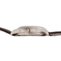 Side view of the Patek Philippe Annual Calendar Moonphase, featuring a silver case, central crown, and brown leather strap.