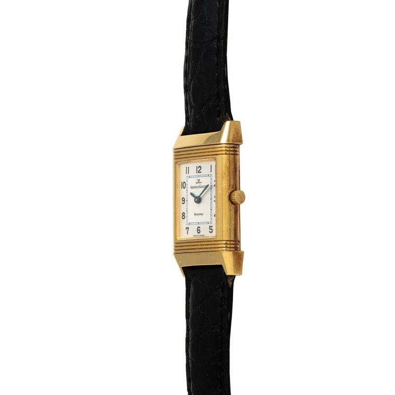 Jaeger-LeCoultre Reverso Classique: a gold rectangular wristwatch by Jaeger-LeCoultre featuring a white face, black numerals, and a black leather strap, displayed upright.