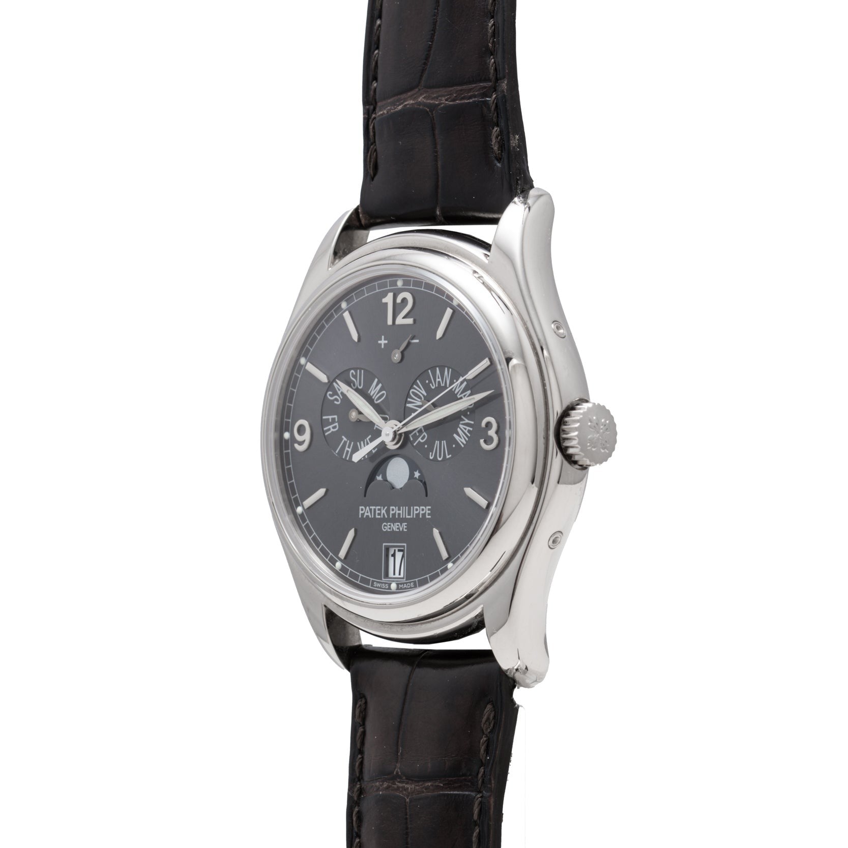 A Patek Philippe Annual Calendar wristwatch in silver with a black leather strap and black dial featuring multiple subdials.