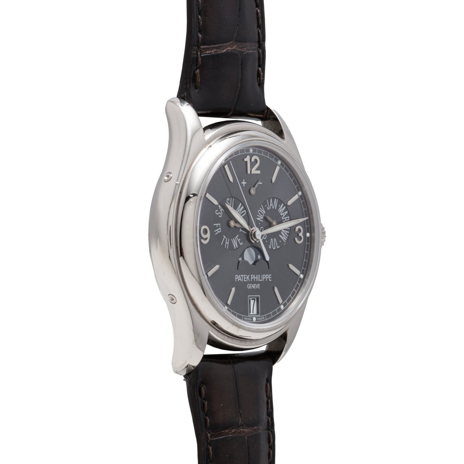 The Patek Philippe Annual Calendar is a luxury wristwatch with a black leather strap, silver case, and multiple dials.
