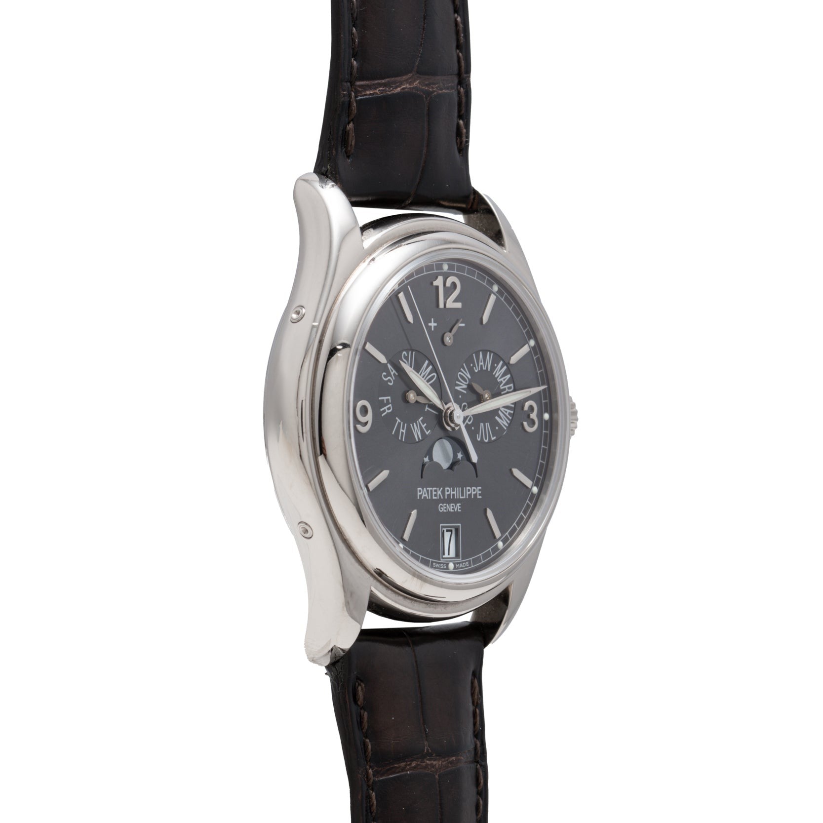 The Patek Philippe Annual Calendar is a luxury wristwatch with a black leather strap, silver case, and multiple dials.