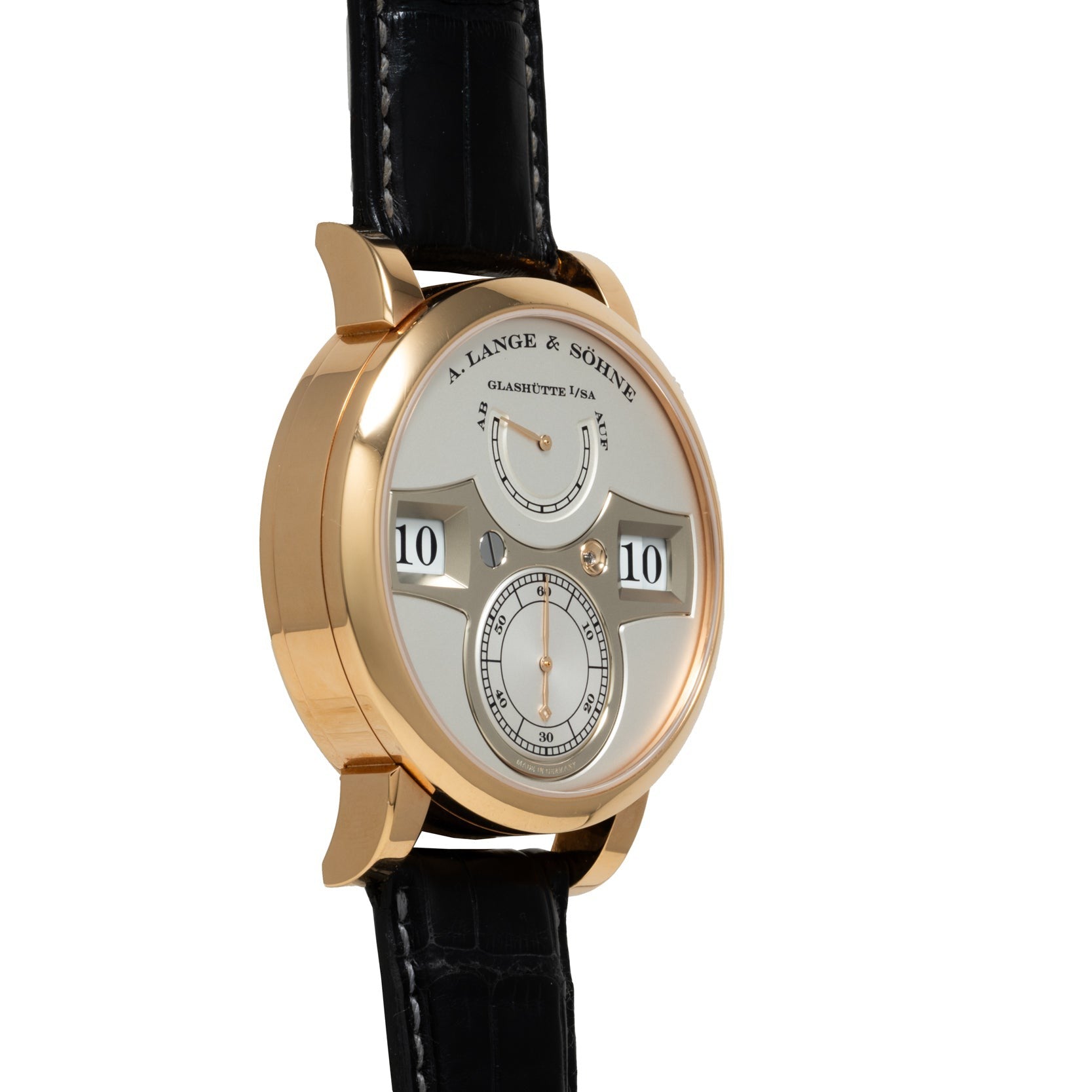 A Lange & Sohne Zeitwerk gold wristwatch featuring a digital time display and a black leather strap.