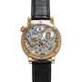 The Zeitwerk by Lange & Sohne features a luxury watch back with exposed intricate gears and mechanisms paired with a black leather strap.
