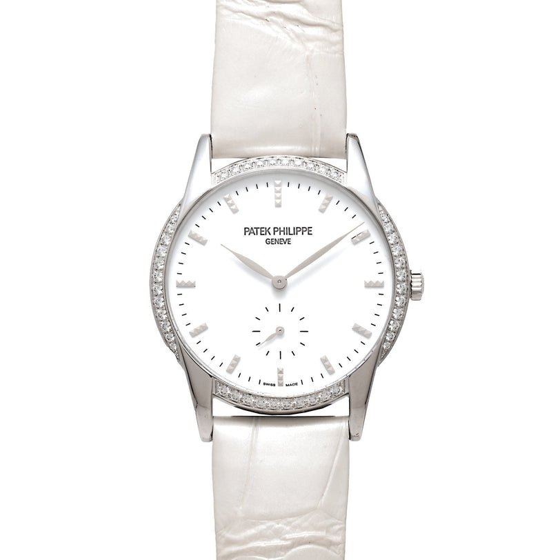 The Patek Philippe Calatrava features a silver case, diamond bezel, minimalist white dial, and a white leather strap.