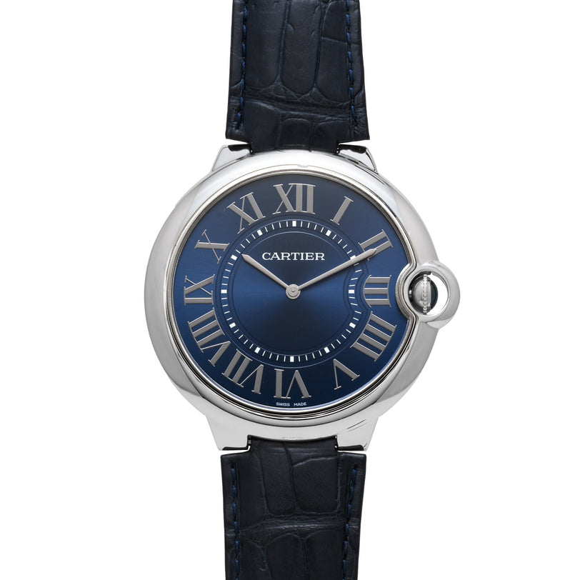 The Cartier Ballon Bleu is a silver watch featuring a blue dial, Roman numerals, and a black leather strap.