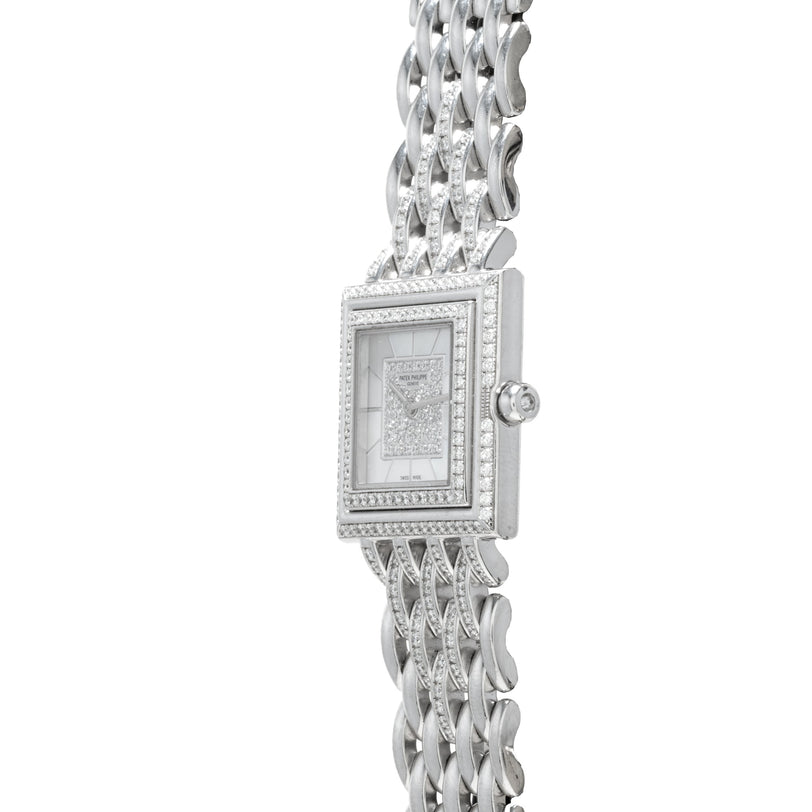 The Patek Philippe Gondolo features a rectangular face with diamond accents on the bezel and band, offering an elegant silver wristwatch design.