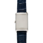 The Jaeger-LeCoultre Reverso Classique Ladies is a silver rectangular watch by Jaeger-LeCoultre, featuring a blue leather strap and an unmarked watch face.