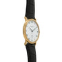 Patek Philippe Calatrava gold watch featuring a white dial with Roman numerals and a black leather strap, displayed at an angle.