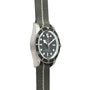 Side view of the TUDOR Black Bay 58 Silver dive watch featuring a black dial, black bezel, and a grey fabric strap with a white stripe.