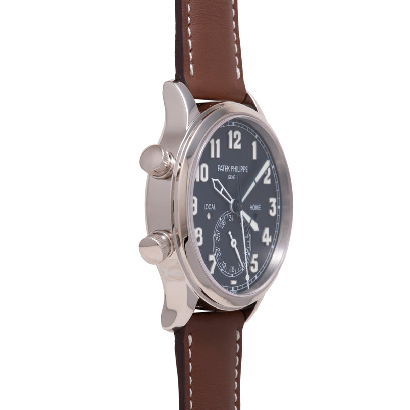 Stainless steel watch with black dial, Arabic numerals, dual time zone subdial marked "LOCAL" and "HOME," brown leather strap