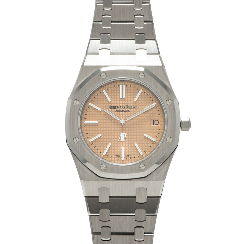 Stainless steel Audemars Piguet Royal Oak watch with salmon dial, white indices, and integrated metal bracelet.