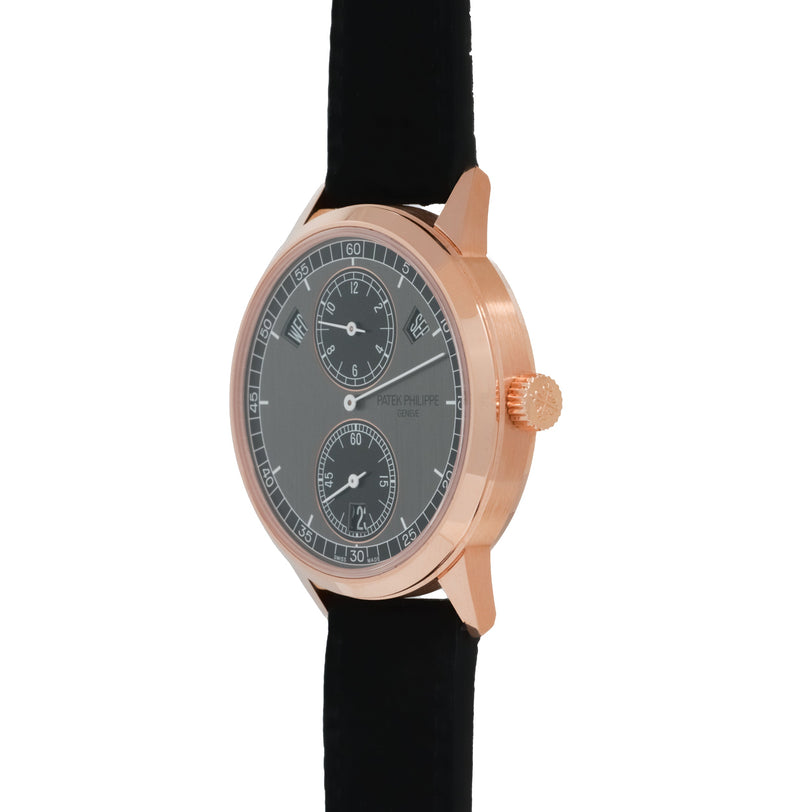 Rose gold watch with dark gray dial featuring three sub-dials, regulator layout, and black leather strap.