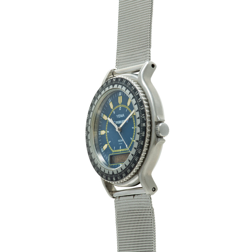 Stainless steel watch with blue dial, gold hour markers, rotating bezel, and mesh band.