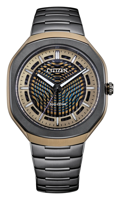 Black and gold titanium watch with geometric dial pattern, white hands, and matching bracelet.