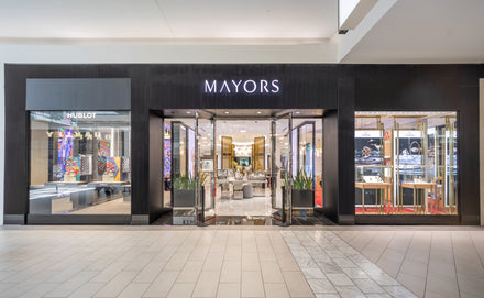 Exterior view of a MAYORS jewelry store in a mall, with glass doors and displays inside.