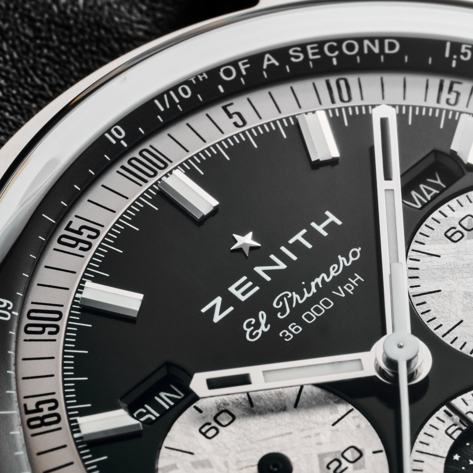 Close-up of the Zenith Chronomaster Original Triple Calendar Limited Edition for Hodinkee watch face, showing detailed markings, chronograph subdials, and 36,000 VpH on a black and silver dial—a showcase of Zeniths modern chronograph design.