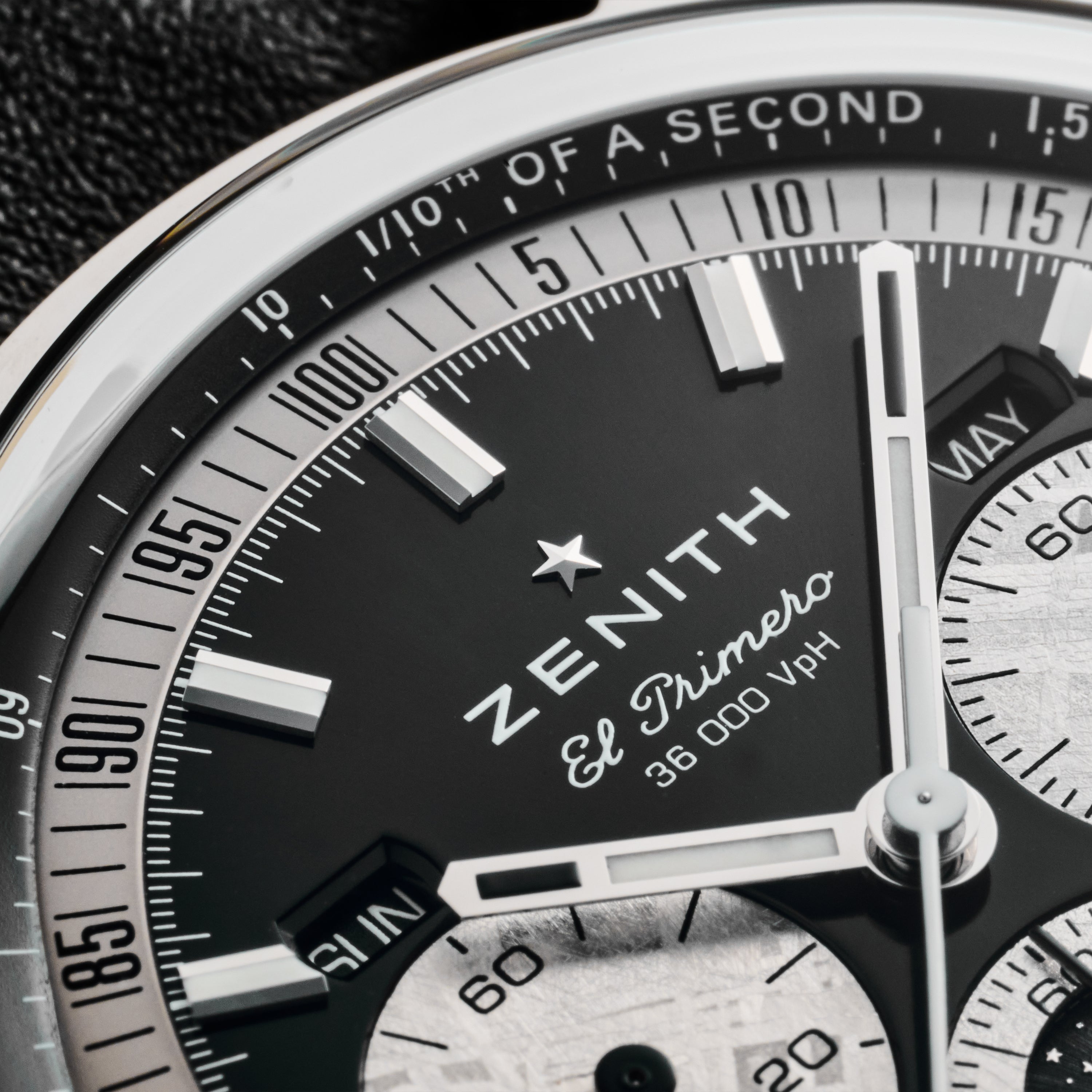 Close-up of the Zenith Chronomaster Original Triple Calendar Limited Edition for Hodinkee watch face, showing detailed markings, chronograph subdials, and 36,000 VpH on a black and silver dial—a showcase of Zeniths modern chronograph design.