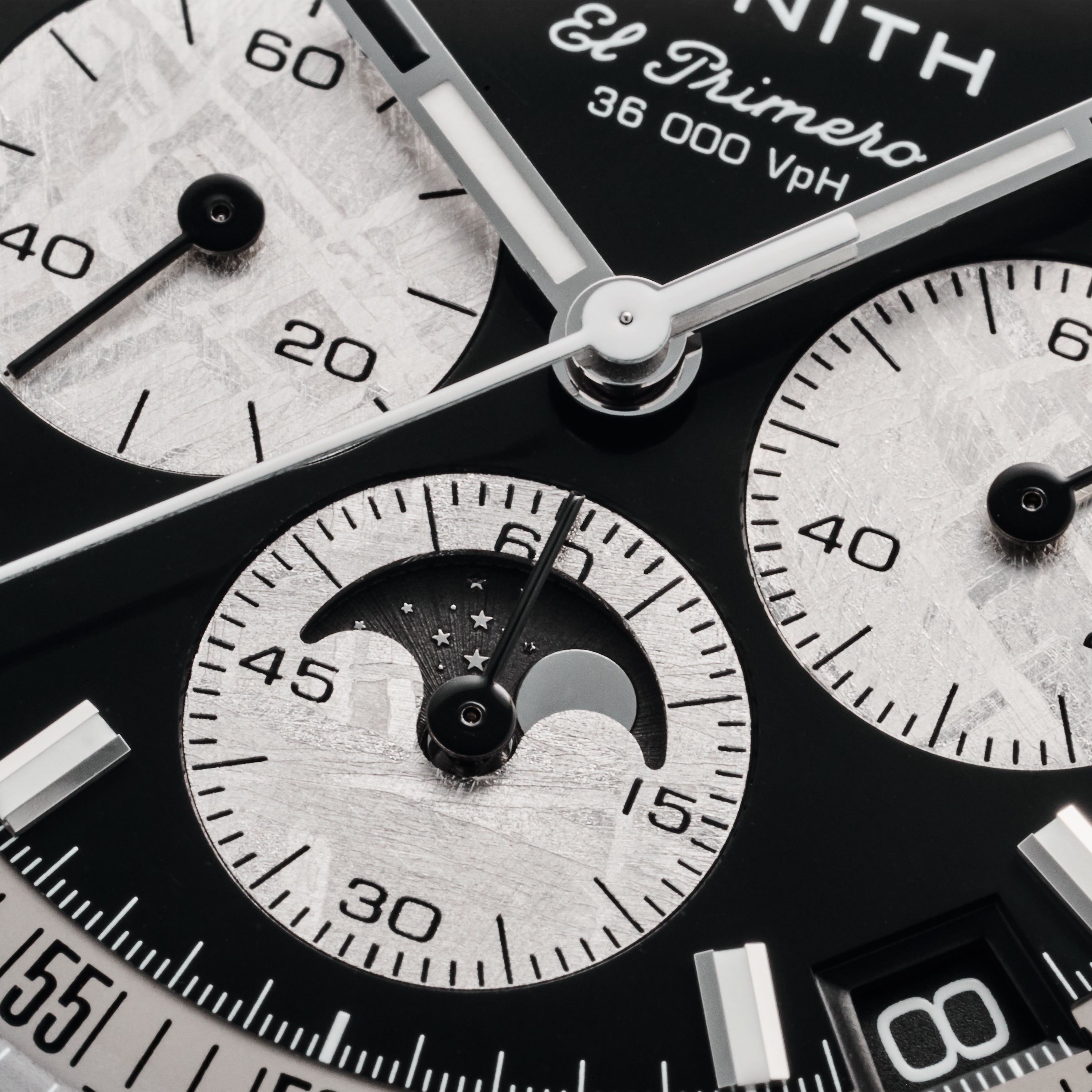 Detailed look at the Zenith Chronomaster Original Triple Calendar Limited Edition for Hodinkee, highlighting subdials, moonphase indicator, and sleek black and silver hour markers—a striking modern triple calendar chronograph by Zenith.