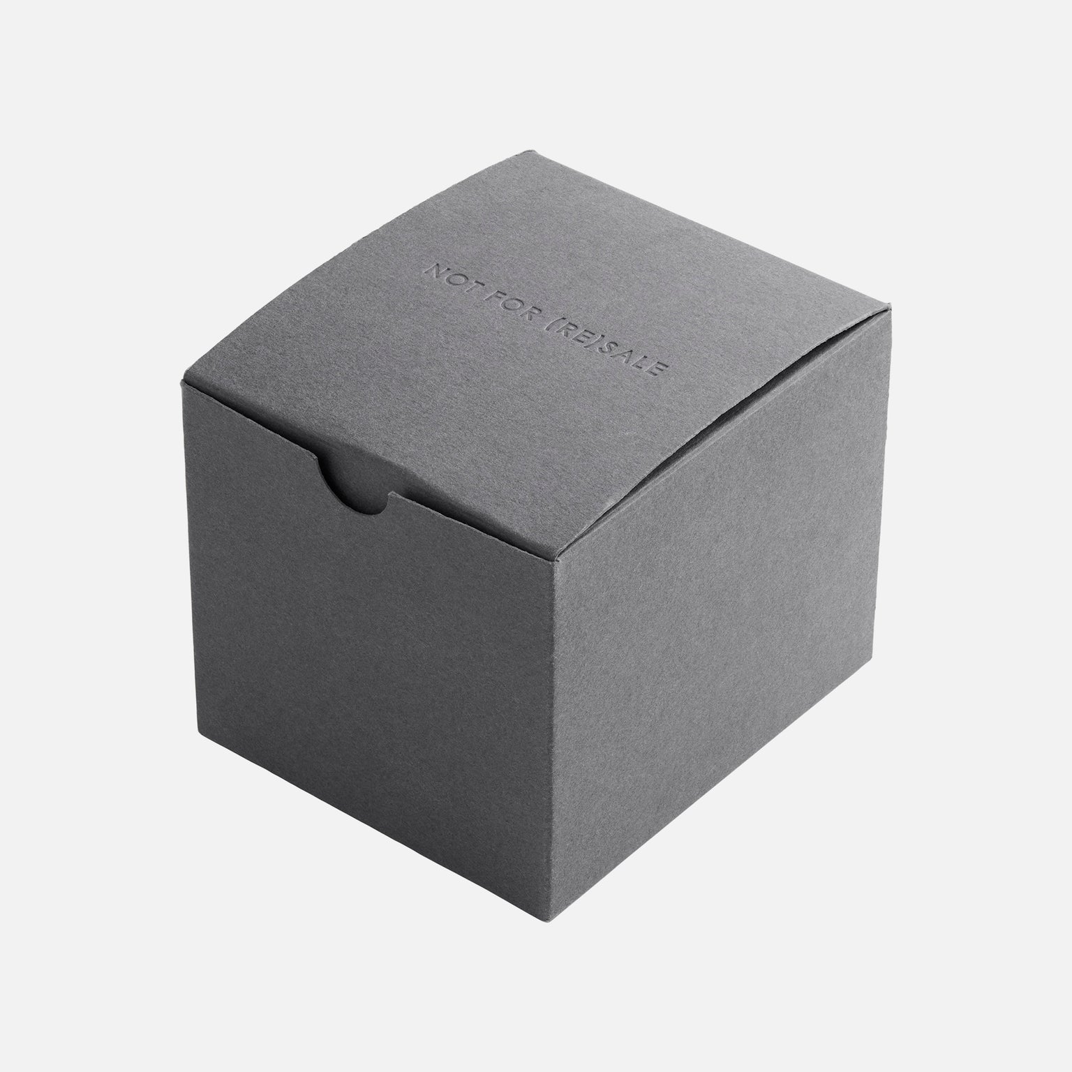 A plain, closed, gray cardboard box with NOT FOR RESALE embossed on the lid, photographed against a white background—possibly linked to the Hublot Classic Fusion Titanium Limited Edition For Hodinkee by Hublot.