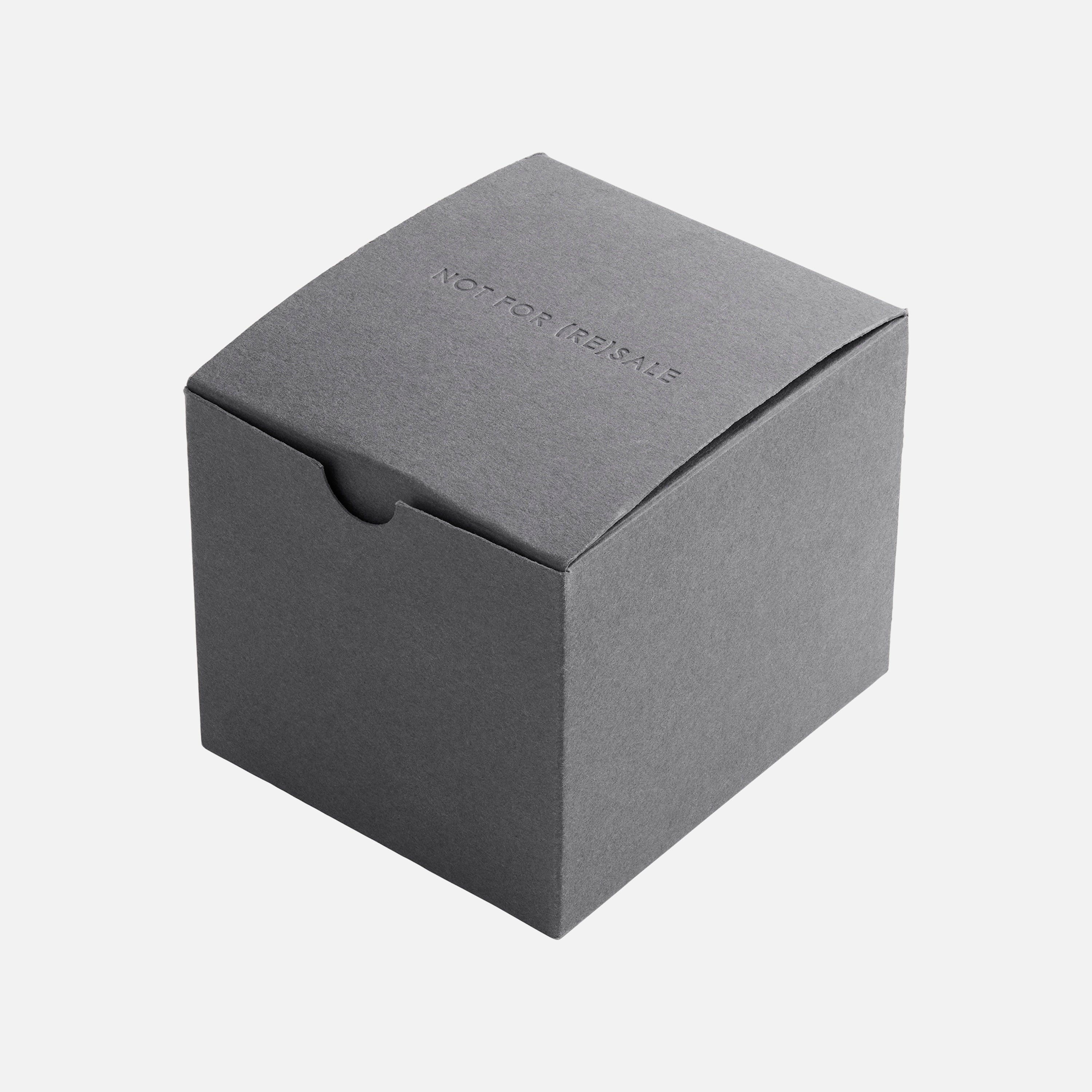 A plain, closed, gray cardboard box with NOT FOR RESALE embossed on the lid, photographed against a white background—possibly linked to the Hublot Classic Fusion Titanium Limited Edition For Hodinkee by Hublot.