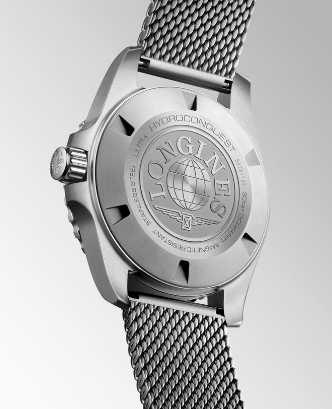 Silver watch with mesh band and visible brand logo on a light gray background