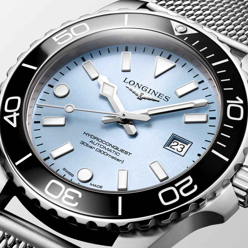 Longines watch with silver case and blue dial on a white background