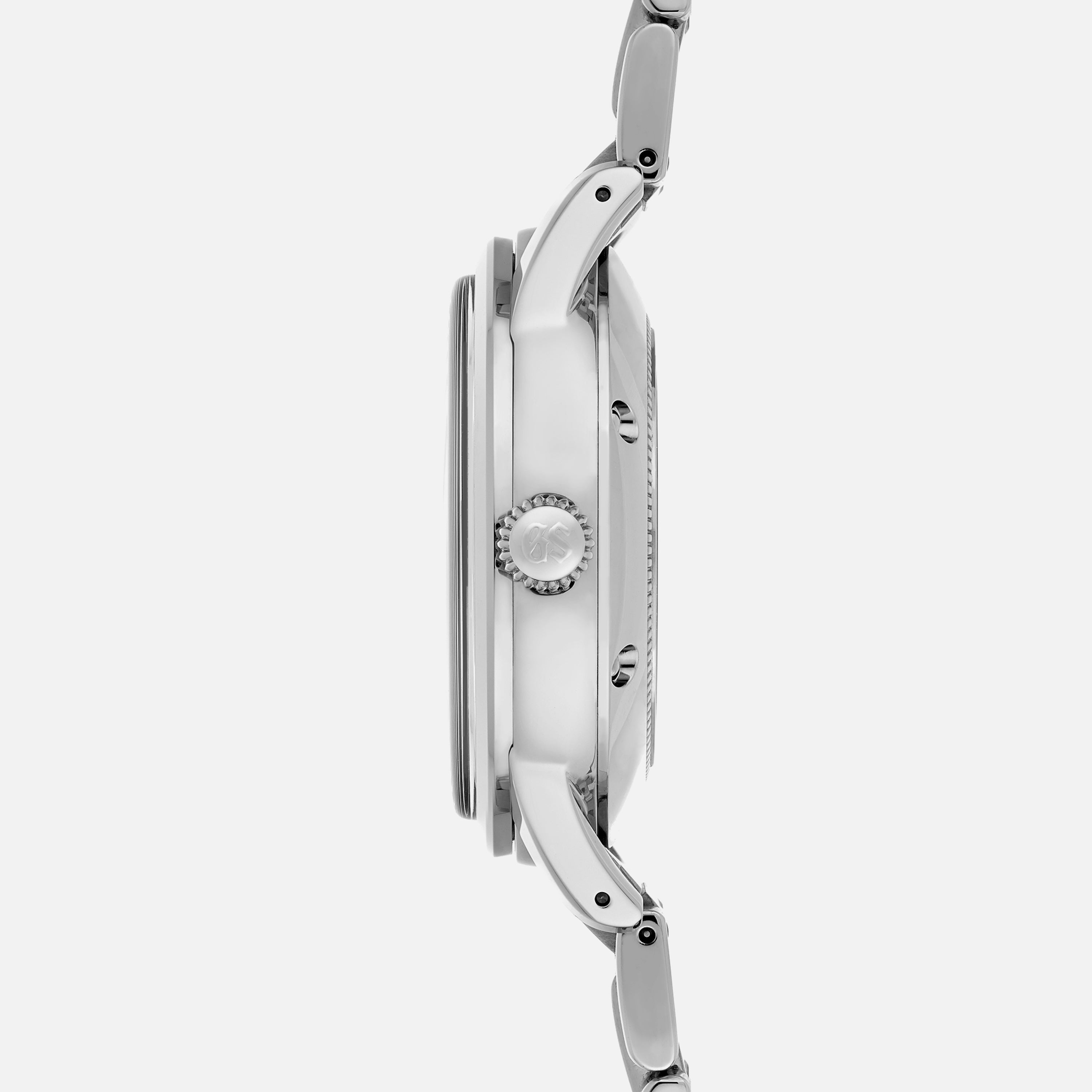 Side view of the Grand Seiko Automatic GMT SBGM239 Limited Edition for HODINKEE, with a metal bracelet, showing its crown and case profile against a plain white background. Features a Twilight Blue Dial.