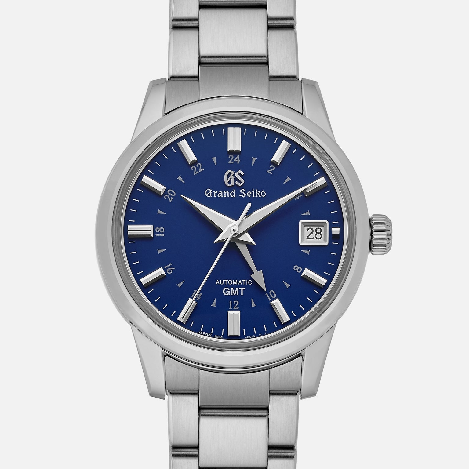 The Grand Seiko Automatic GMT SBGM239 Limited Edition for HODINKEE features a stainless steel case, Twilight Blue dial with silver hour markers, date window at 3 o’clock, and a distinctive GMT hand.