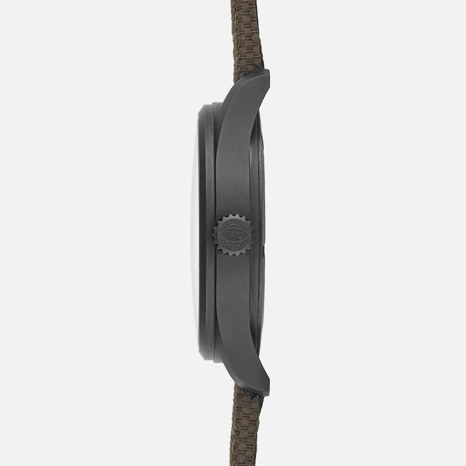 Side view of the IWC Schaffhausen Pilots Watch Mark XVIII Edition HODINKEE by IWC, showcasing its matte dark case, textured crown, and woven fabric strap—crafted as a limited edition.