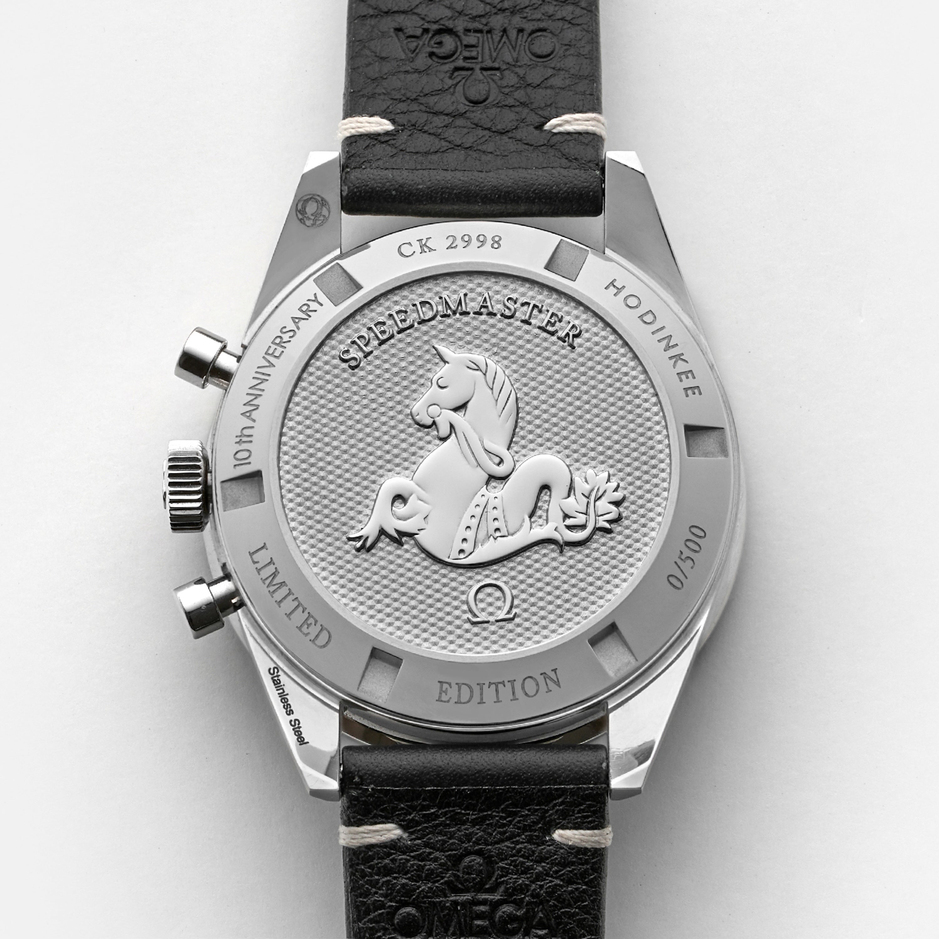 The OMEGA Speedmaster Hodinkee 10th Anniversary Limited Edition features a raised horse emblem, engraved text, and unique numbering (0/500) on the caseback, celebrating Hodinkee’s 10th anniversary with its iconic chronograph movement.