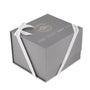 Gray gift box with white ribbon, featuring the Breitling logo and Navitimer B01 Chronograph 46 name in gold and white text on the lid.