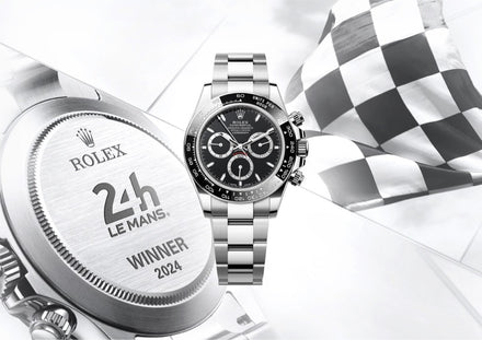 Rolex Daytona watch with 24h Le Mans Winner 2024 engraving and a checkered racing flag in the background.
