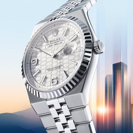 Silver Rolex Land-Dweller watch with a cityscape background