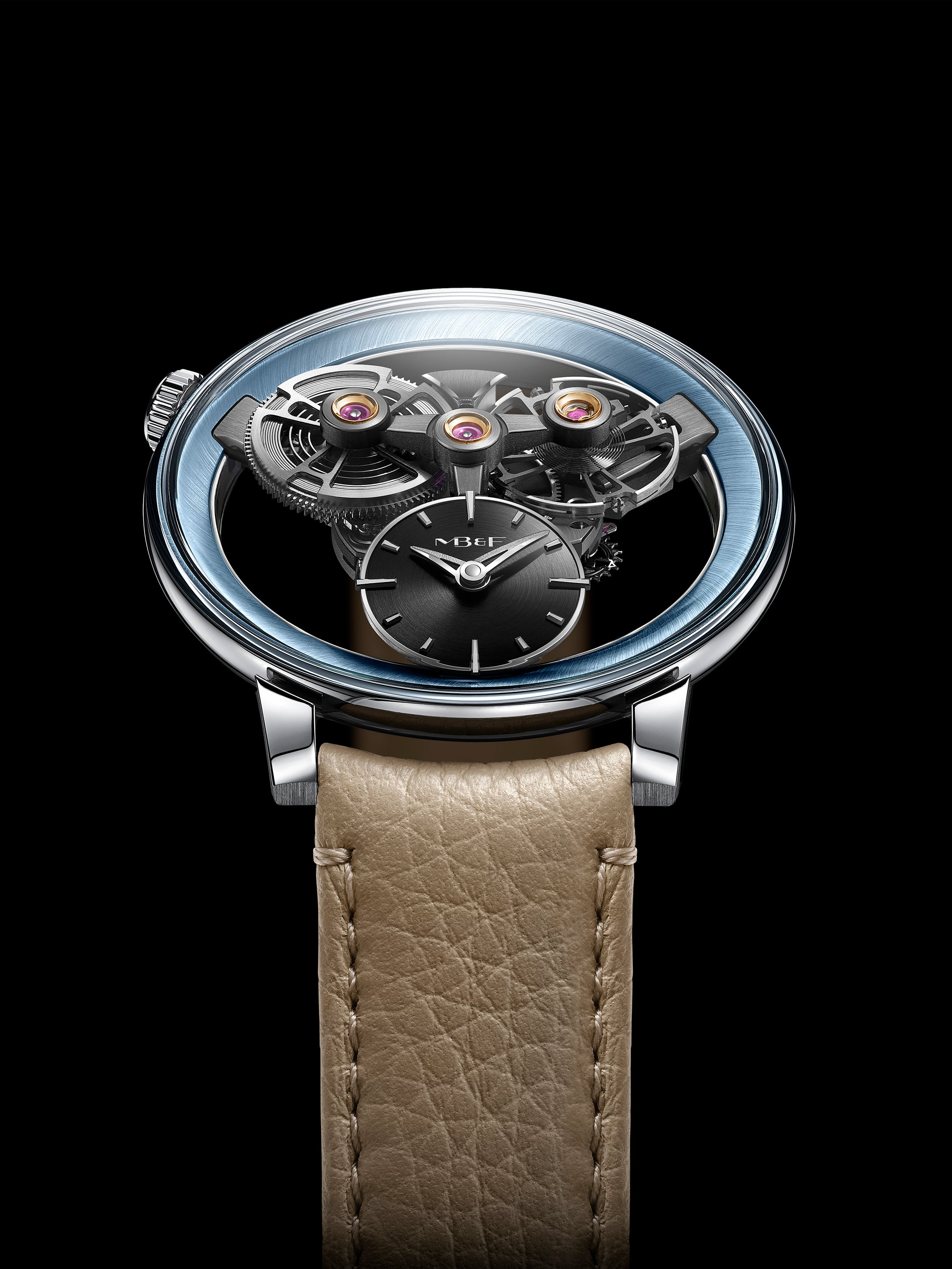 The MB&F SP One Platinum showcases exposed gears and a tan leather strap, set against a striking black background.