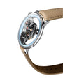 The MB&F SP One Platinum is a luxury skeleton watch featuring exposed gears, a silver case, and a light brown leather strap, displayed on a white background.