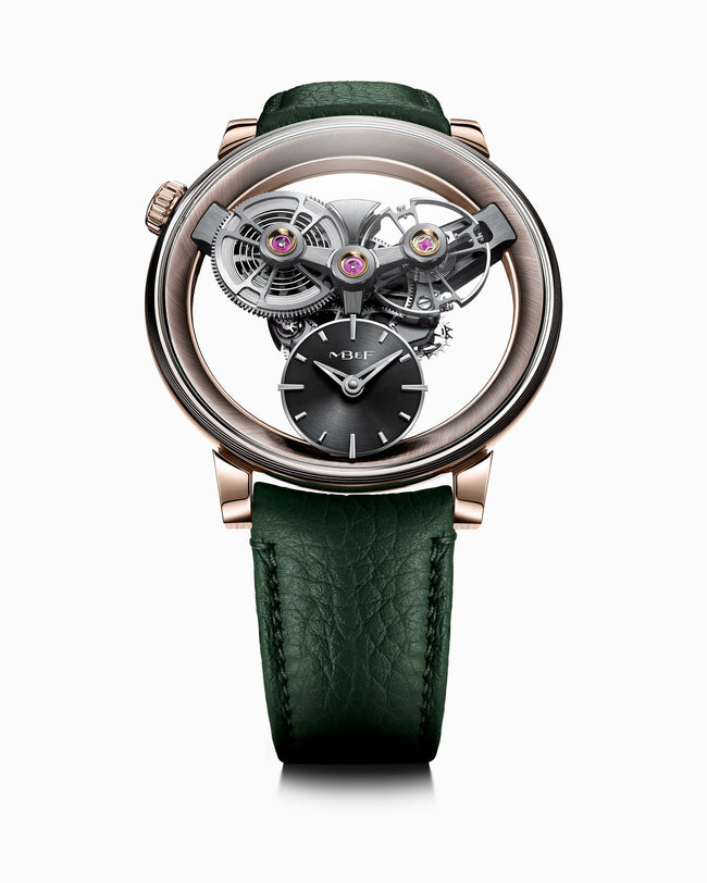 The MB&F SP One Rose Gold is a luxury watch featuring exposed gears, a black dial, and a green leather strap, showcased on a white background.