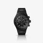 The Porsche Design Chronograph 1 All Black Numbered Edition features a black chronograph dial, metal band, three subdials, and a date display set against a white background.