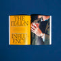 An open HODINKEE Magazine, Volume 12 by Hodinkee reveals a bold yellow “The Italian Influence” page and a photo of someone with a drink, capturing the feel of iconic watch ads on the facing page.