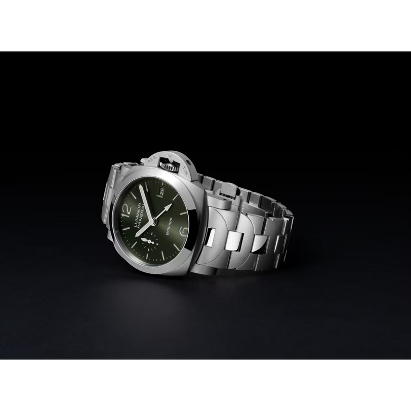 The Panerai Luminor Quaranta BiTempo, a luxury automatic stainless steel watch with a green dial, silver markers, and a metal link bracelet, is displayed against a black background.