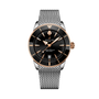 The Breitling Superocean Heritage B31 Automatic 42 features a black dial with gold accents and a silver mesh metal strap, displayed on a black background.