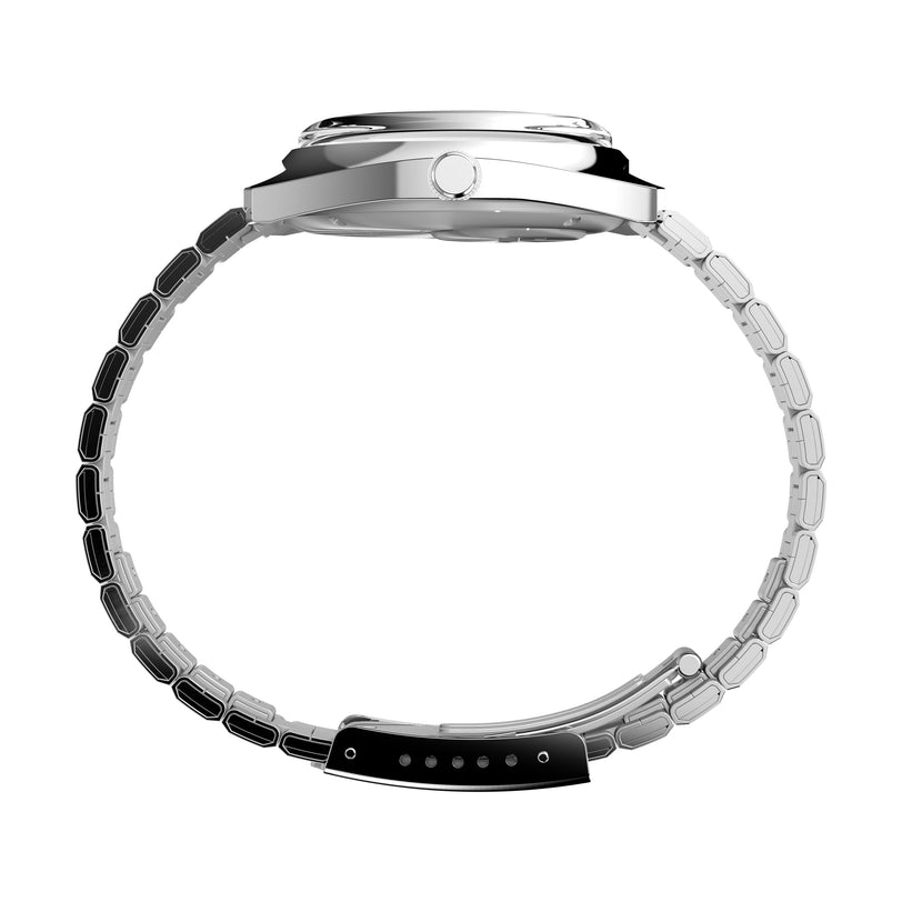 Side view of the Timex Q Timex 1975 Enigma Reissue, a silver metal wristwatch with a round face and segmented band, showing the crown and clasp, displayed against a white background.