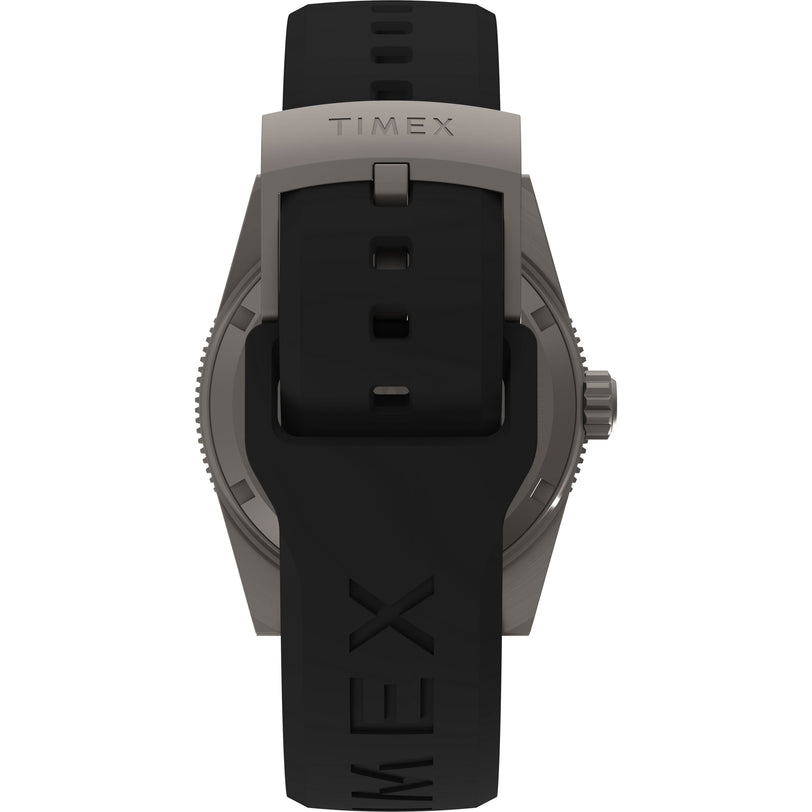 A close-up of the Timex G TI AU SW DEEP WTR REEF 41 BLAK DL 25 shows its titanium case, crown, sapphire crystal, and a black rubber strap with TIMEX embossing and silver buckle.