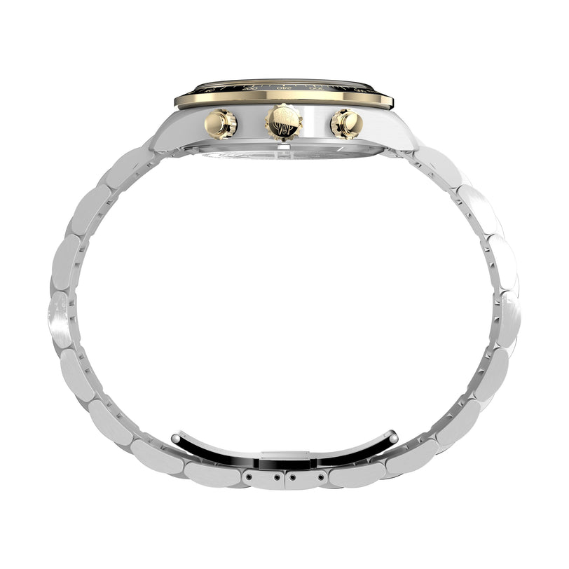 Side view of the Timex Waterbury Heritage Chronograph featuring a silver stainless steel band, gold crown and pushers, and a black tachymeter bezel on the watch face.