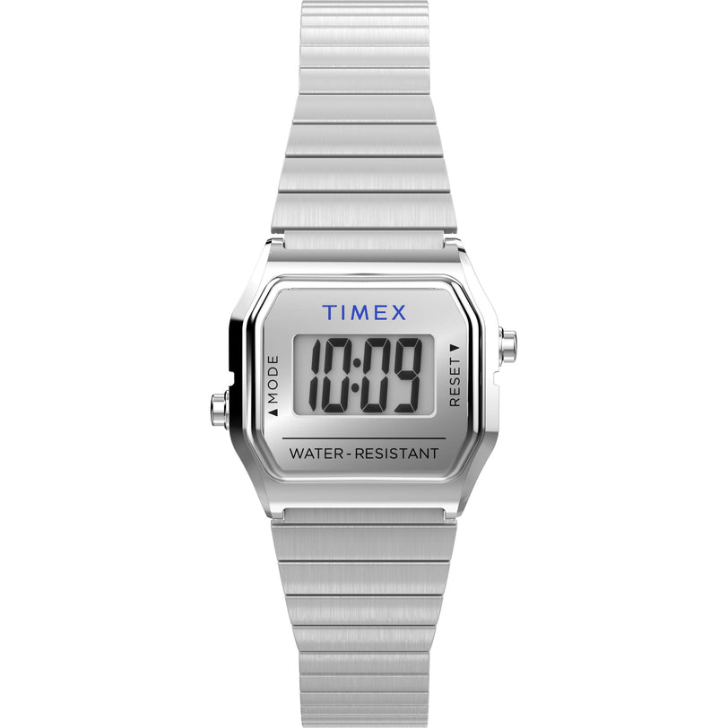 The Timex Teeny Tiny is a digital wristwatch with a rectangular face displaying 10:09 and WATER RESISTANT. It has a brushed stainless-steel case and band, ideal for fans of compact watches.