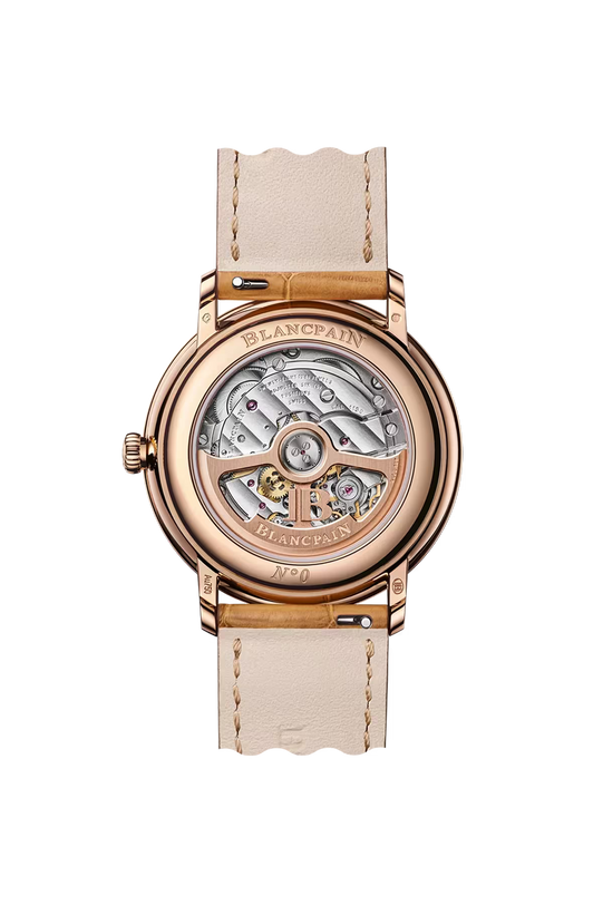 Rose gold watch with visible mechanical movement through case back, cream leather strap, and cream dial.