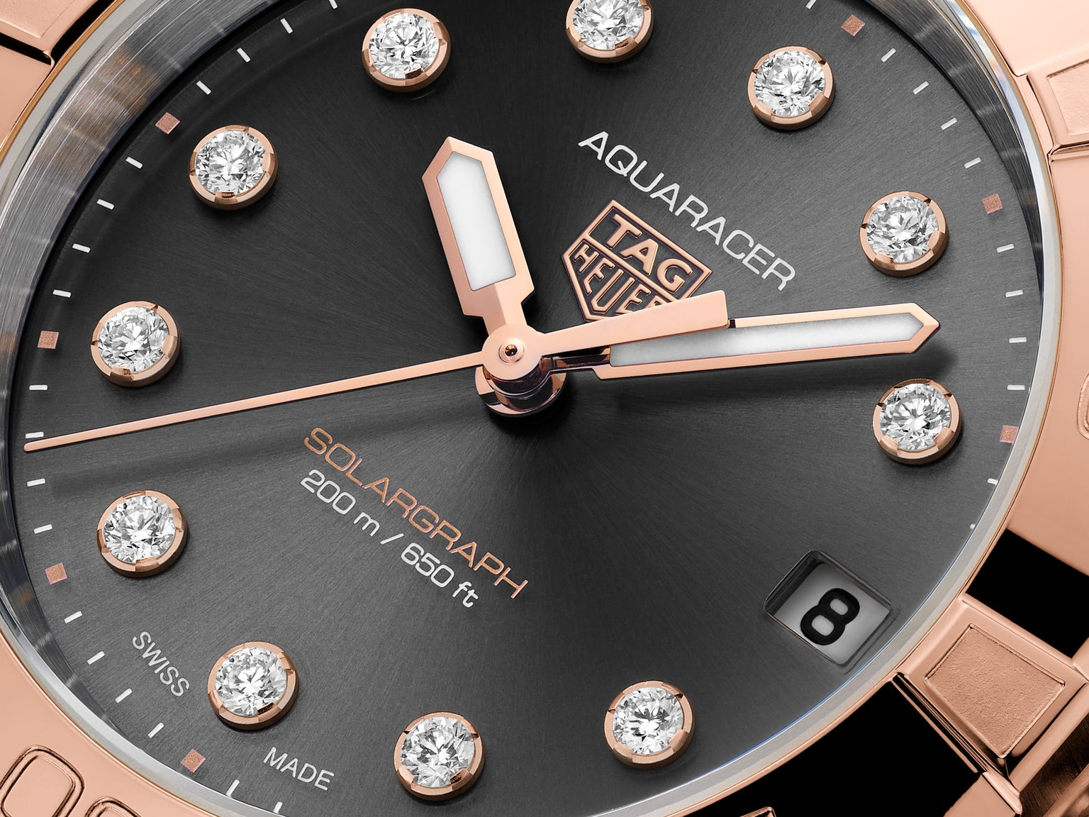 Close-up of a TAG Heuer Aquaracer Professional 200 Solargraph watch, featuring diamond hour markers and a date display at 3 o’clock.