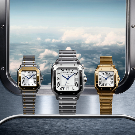 Three luxury wristwatches on display in front of an airplane window showing clouds and sky.
