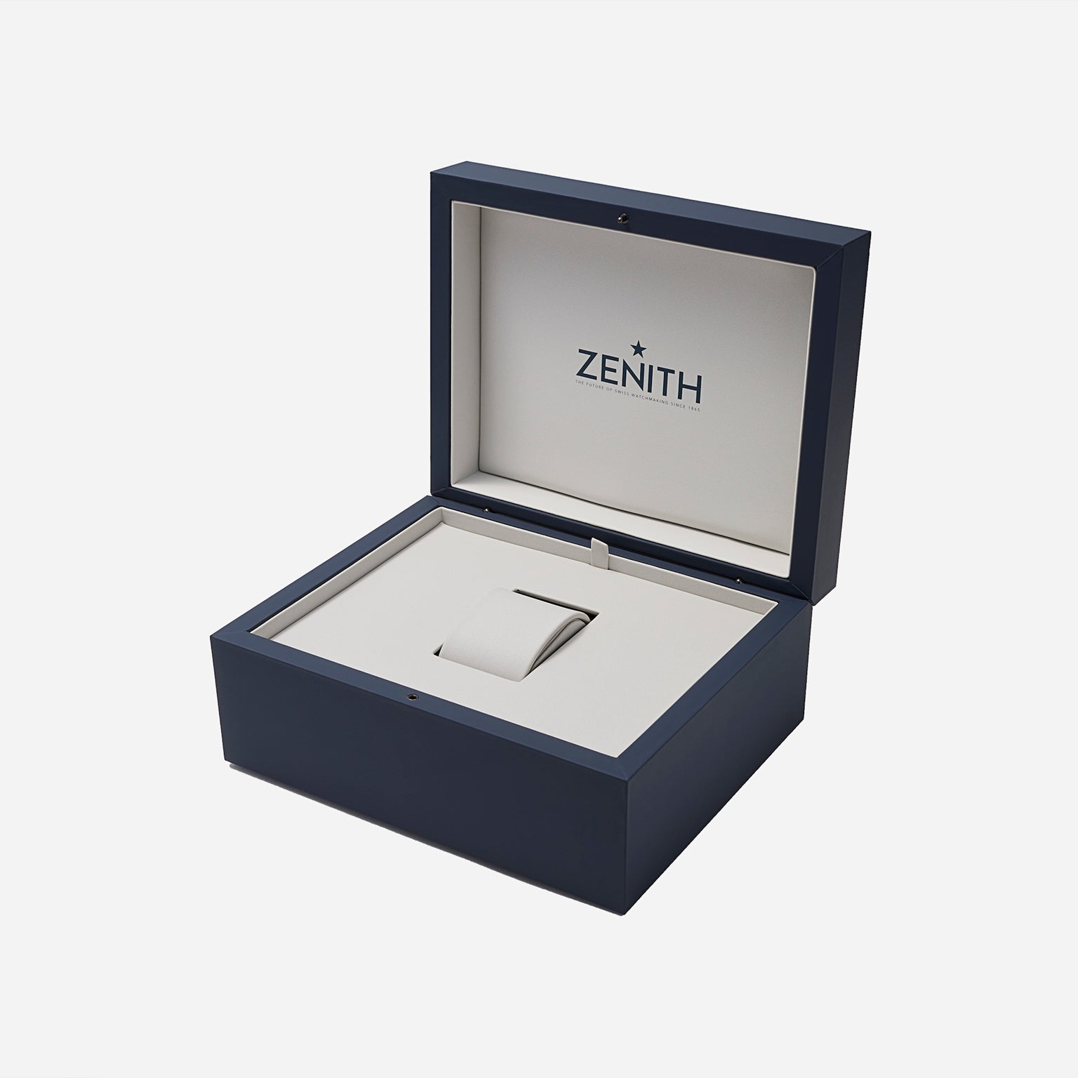 An open navy blue and beige Zenith watch box displays an empty cushioned slot—an ideal home for your Zenith Chronomaster Original Limited Edition For Hodinkee or any classic Zenith timepiece.