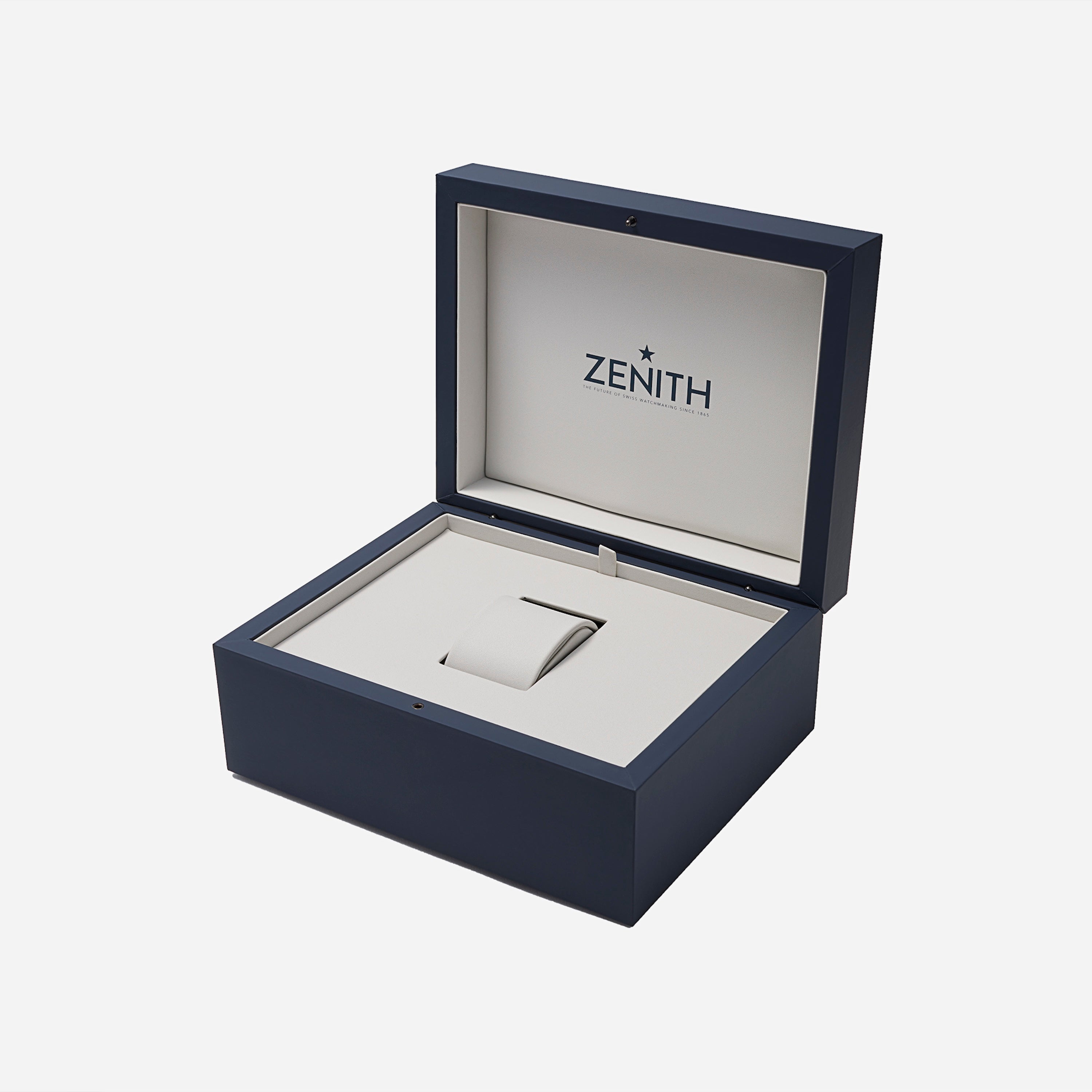 An open navy blue and beige Zenith watch box displays an empty cushioned slot—an ideal home for your Zenith Chronomaster Original Limited Edition For Hodinkee or any classic Zenith timepiece.